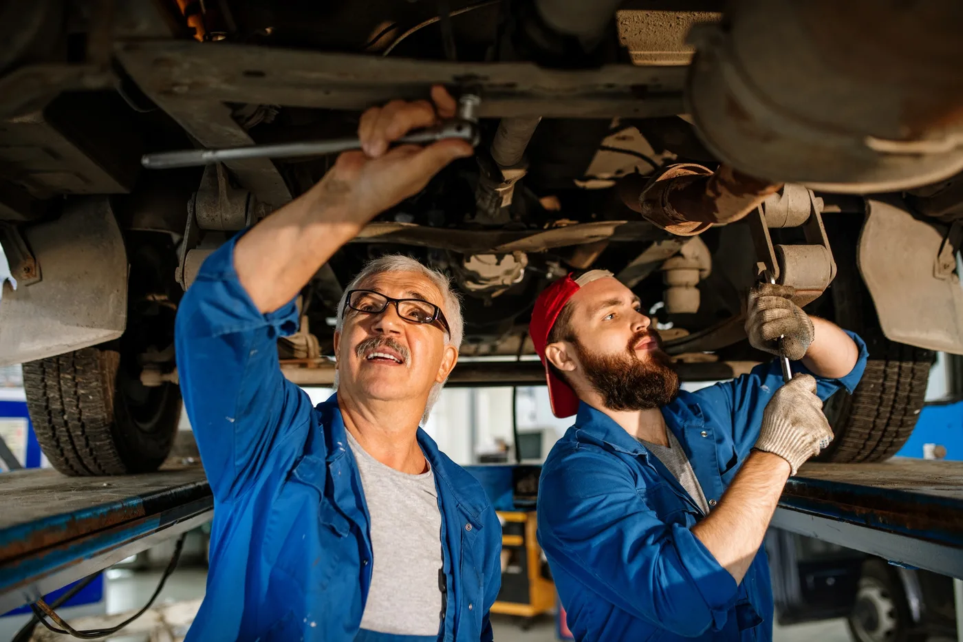 Technicians checking a car engine