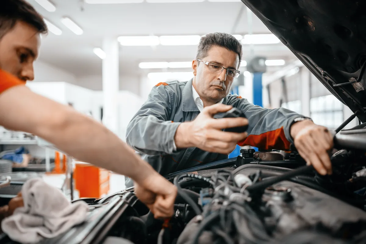 Technicians maintaining a car